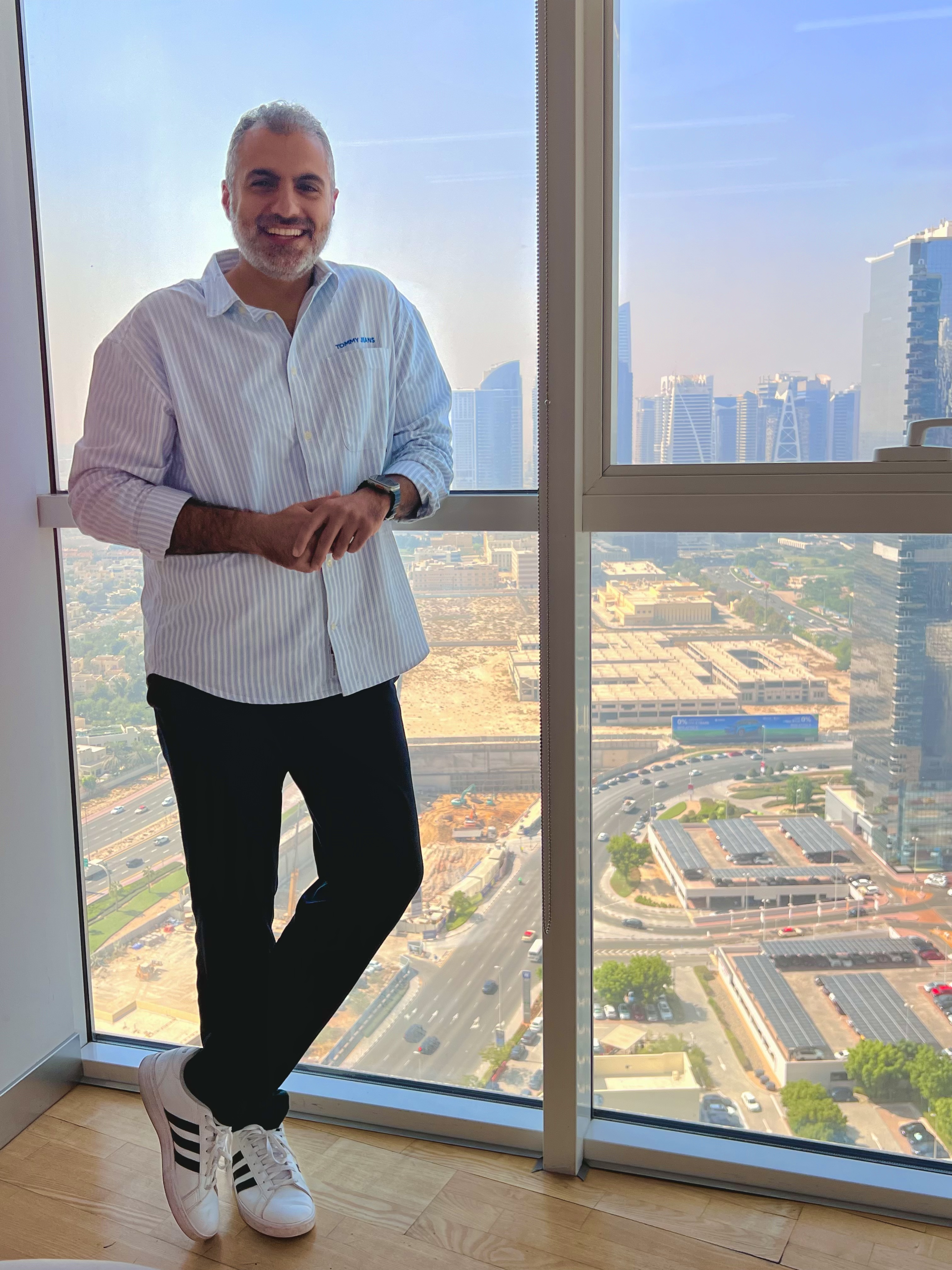 Muhammed at Dubai highrise floor-to-ceiling window